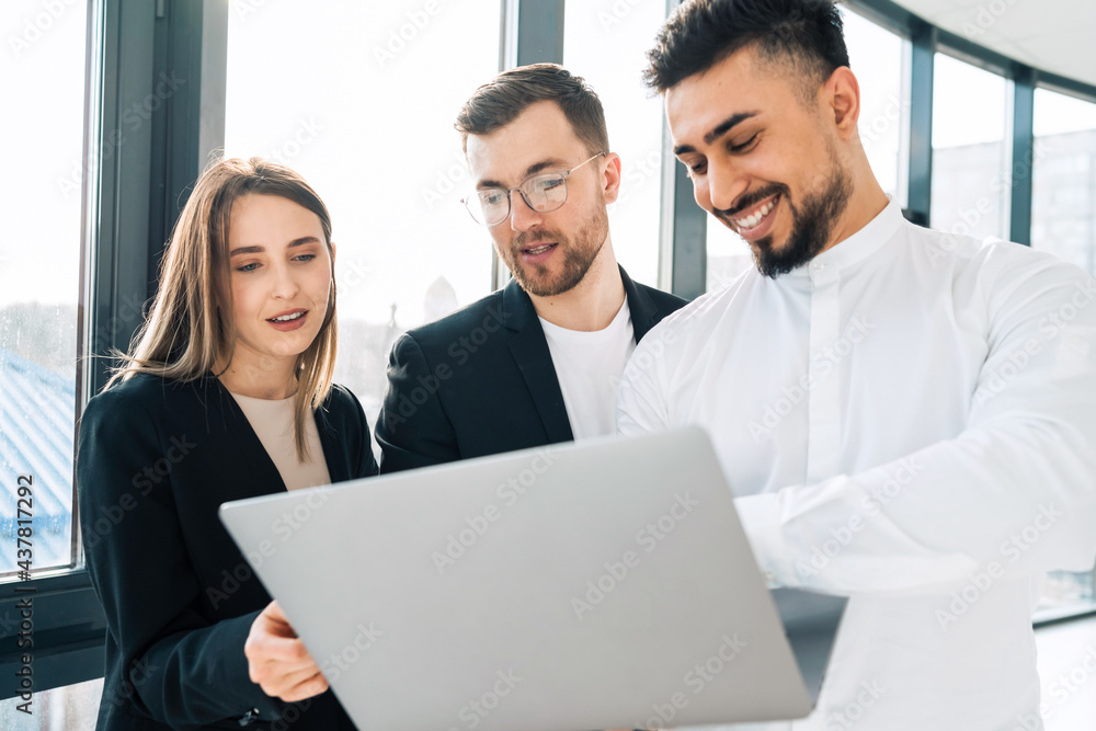Group of multiracial employees of software company consider a new startup in a laptop Group of multiracial employees of software company consider a new startup in a laptop