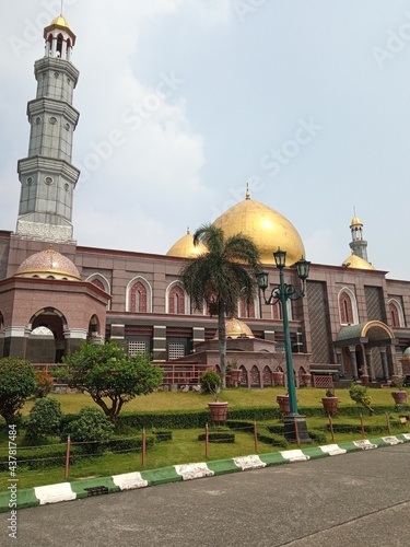 The top of the dome and the minaret of the gold dome of Depok, Indonesia photo