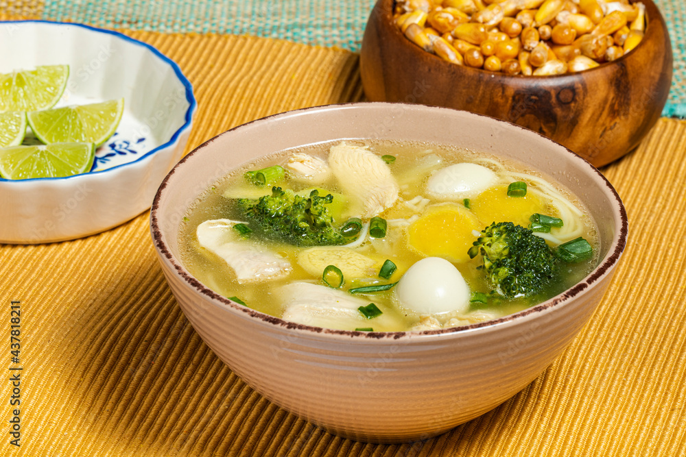 Chicken ginseng soup with broccoli, quail eggs, lemon and toasted peruvian corn. Traditional food. Chicken ginseng soup with broccoli, quail eggs, lemon and toasted peruvian corn. Traditional food.