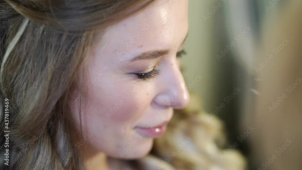 A beautiful girl with long hair do eye makeup. A beautiful girl with long hair do eye makeup.