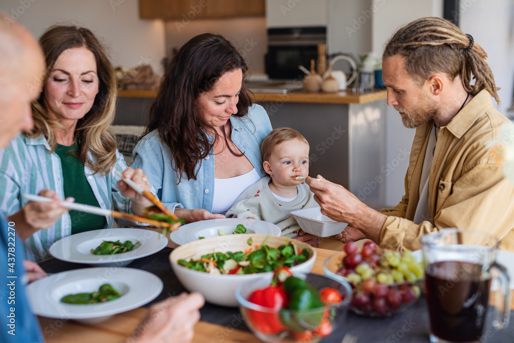 Happy multigeneration family indoors at home eating healthy lunch. Happy multigeneration family indoors at home eating healthy lunch.