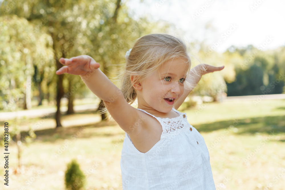 Close up portrait of a little blonde girl on a summer day