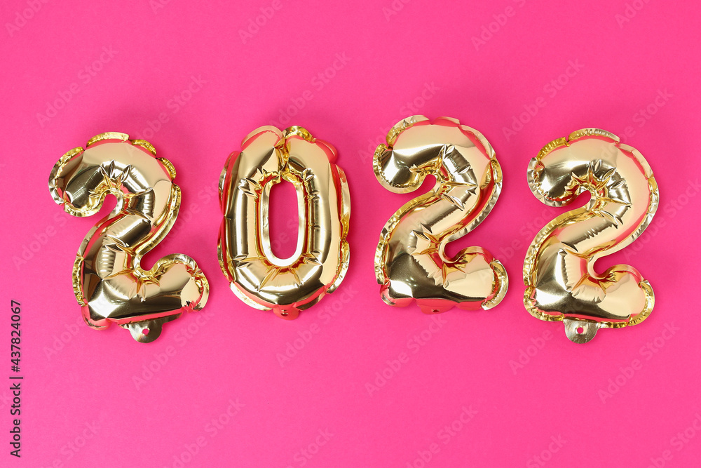 New Year 2022. Foil balloons numbers 2022 on a pink background. New Year Christmas. New Year 2022. Foil balloons numbers 2022 on a pink background. New Year Christmas.