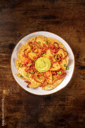 Nachos, top shot on a rustic wooden background with copyspace