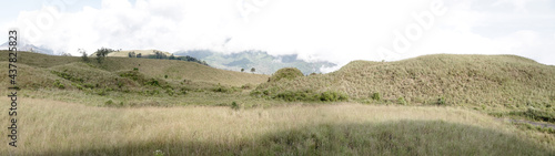 Crater hill of Kawah Wurung on the top of Mount Ijen and Mount Merapi at Bondowoso, Indonesia. Natural landscape background. 