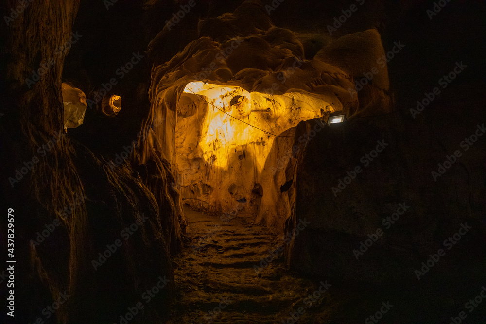 Fototapeta premium Inside view of Karain Cave in Antalya, with natural stalactites and stalagmites around in Turkey