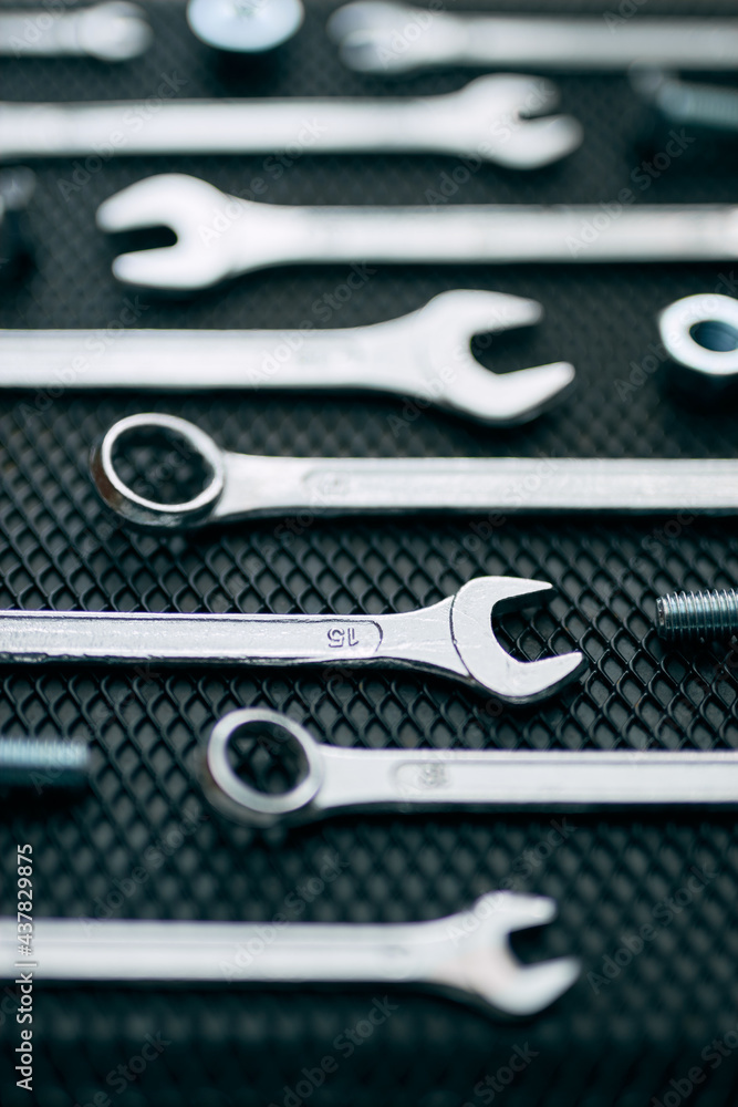 Fototapeta premium Set of chrome wrenches on steel surface. Mechanic tools for maintenance. Hardware tools to fix