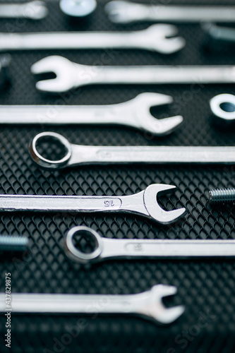 Set of chrome wrenches on steel surface. Mechanic tools for maintenance. Hardware tools to fix