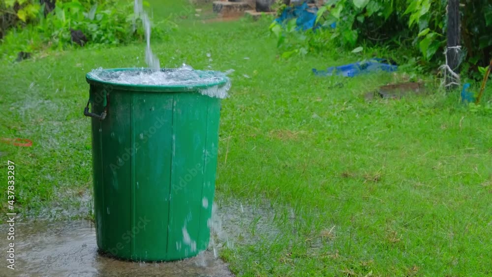 Overflowing rainwater tank green in the park Overflowing rainwater tank green in the park