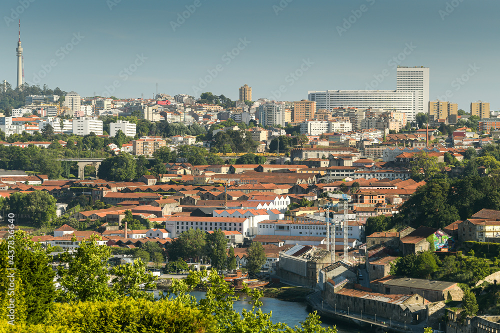 Sunset in beautiful city of Porto from Portugal. View from above with the entire cityscape during a summer day. Landmarks of Europe.