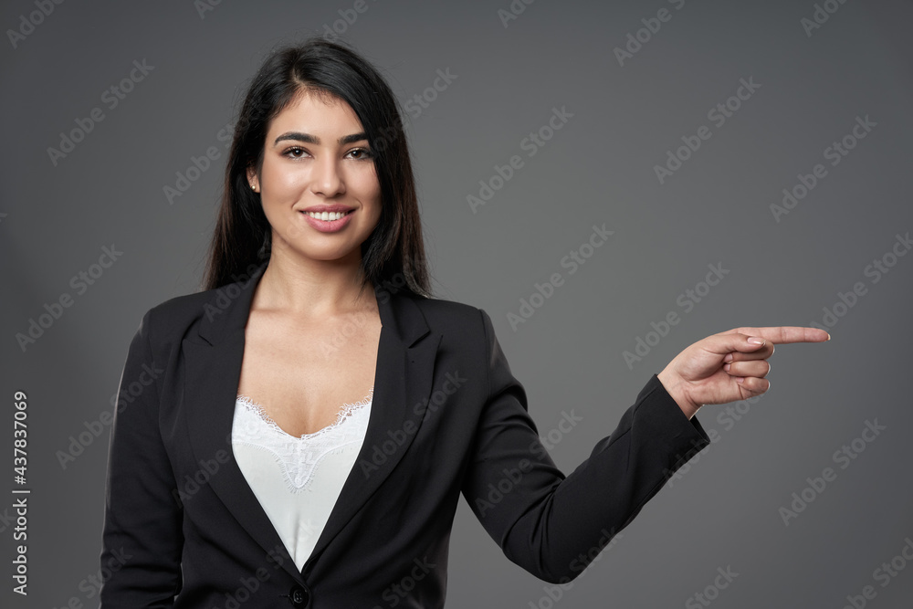 Latin businesswoman pointing to the copyspae Latin businesswoman pointing to the copyspae