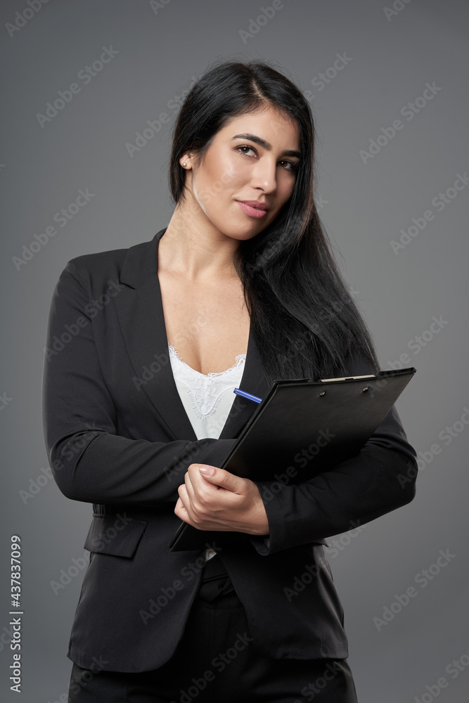 Hispanic businesswoman with clipboard Hispanic businesswoman with clipboard