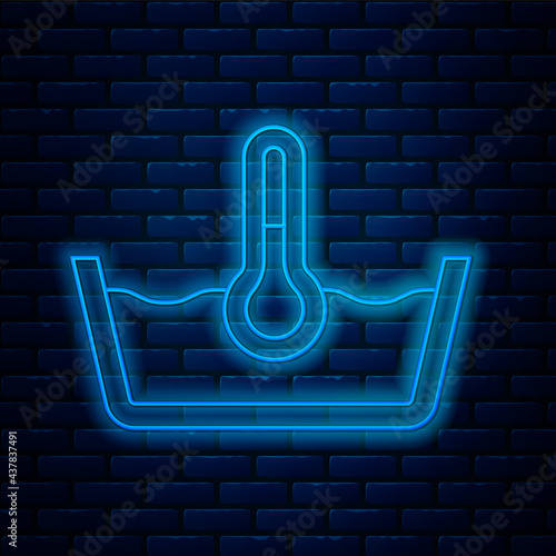 Glowing neon line Temperature wash icon isolated on brick wall background. Temperature wash. Vector