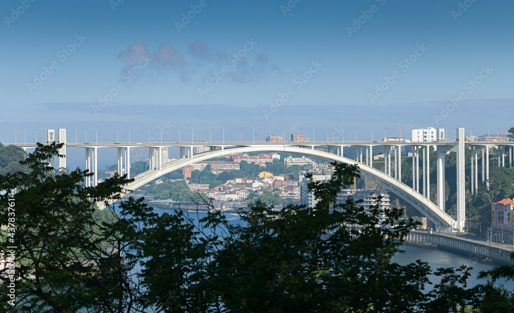 Naklejka premium Ponte da Arrábida landmark bridge in Porto city from Portugal during a beautiful summer day with blue sky.