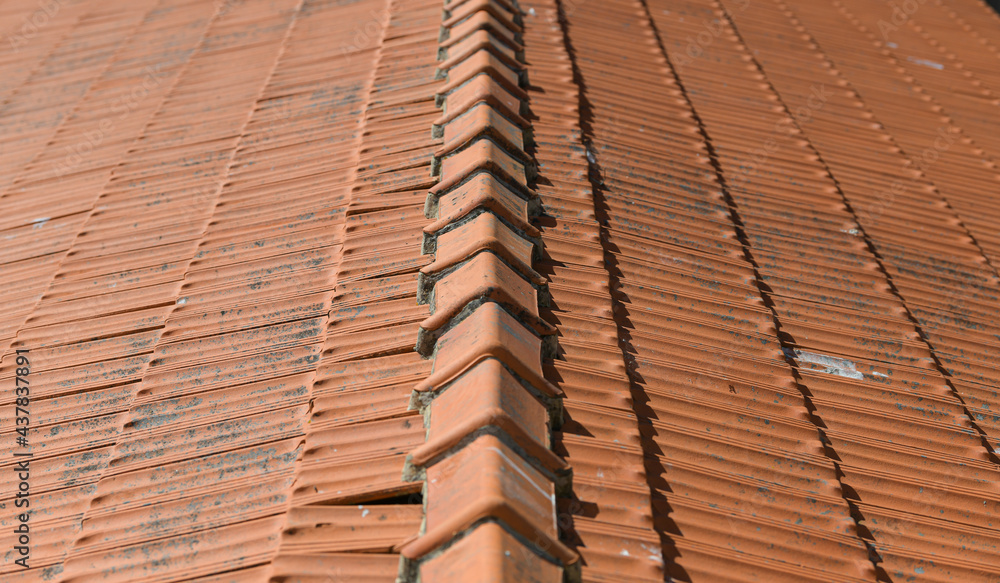 The texture of an orange tile roof building in plain sunlight The texture of an orange tile roof building in plain sunlight