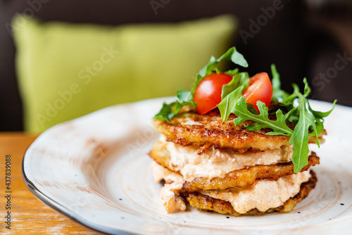 potato pancakes with sauce and vegetables