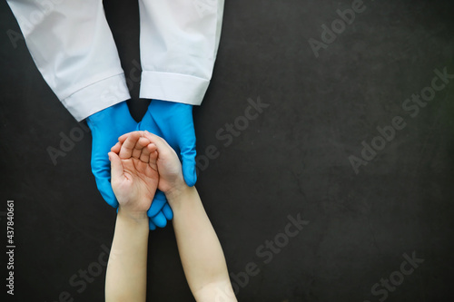 Medical concept. The doctor in gloves holds the patient s hand. The moral help of the doctor to his patients. Cardiologist consultation. Epidemic.