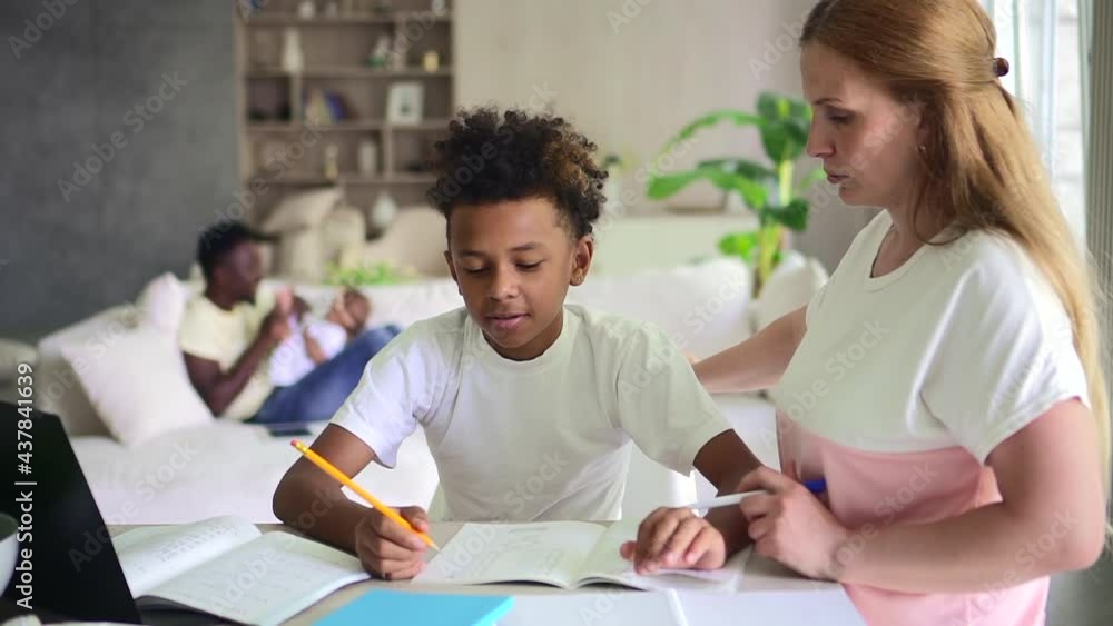 Multi-ethnic family with children teaches at home with mother Spbd. Multi-ethnic family with children teaches at home with mother Spbd.