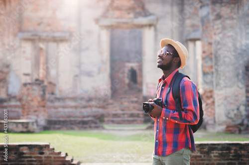 African male photographer happiness to taking pictures of ancient scenery with beautiful asia old buildings