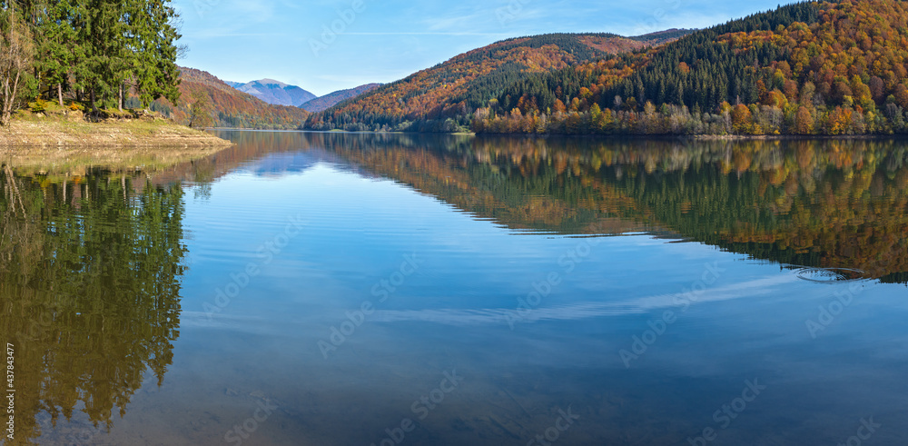 Vilshany water reservoir on the Tereblya river, Transcarpathia, Ukraine. Picturesque lake with clouds reflection. Beautiful autumn day in Carpathian Mountains.