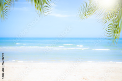 Fototapeta Naklejka Na Ścianę i Meble -  Sand beach soft wave with coconut or palm leaves at coast with blue sea and blue sky. nature ocean outdoor. tropical tourist vacation summer travel in holidays concept.