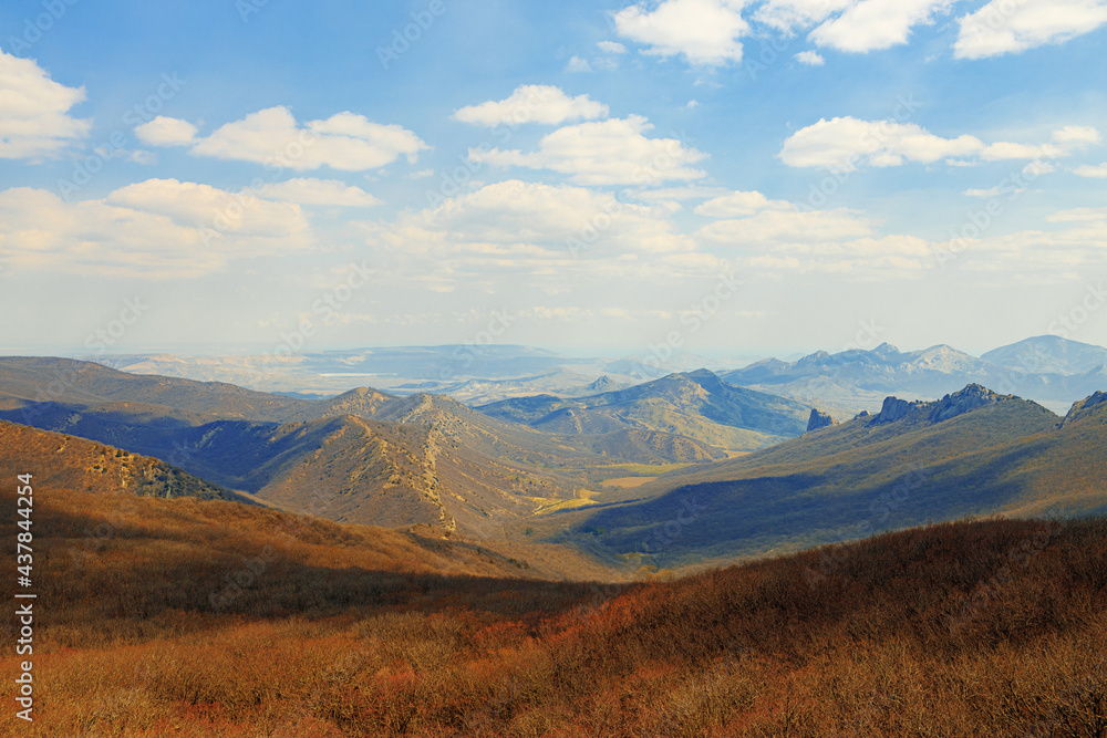 Mountains landscape against blue sky with clouds on sunny day