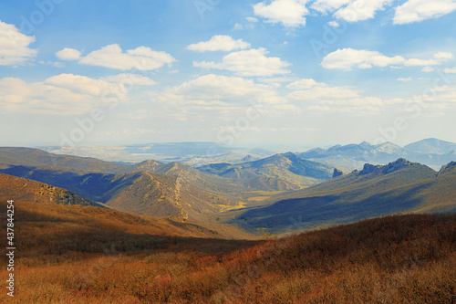 Mountains landscape against blue sky with clouds on sunny day © fotofabrika