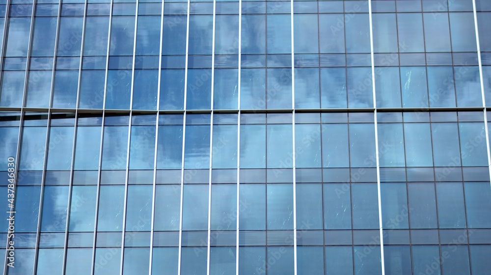 Modern architecture with sun ray. Glass and steel facade on a bright sunny day with sunbeams on the blue sky. Economy, finances, business activity concept. Modern architecture with sun ray. Glass and steel facade on a bright sunny day with sunbeams on the blue sky. Economy, finances, business activity concept.