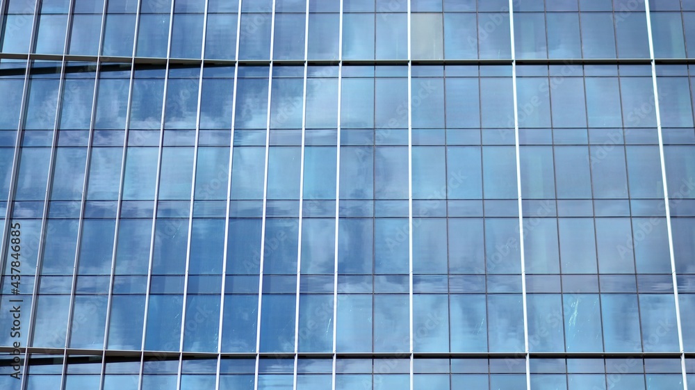 Modern architecture with sun ray. Glass and steel facade on a bright sunny day with sunbeams on the blue sky. Economy, finances, business activity concept. Modern architecture with sun ray. Glass and steel facade on a bright sunny day with sunbeams on the blue sky. Economy, finances, business activity concept.