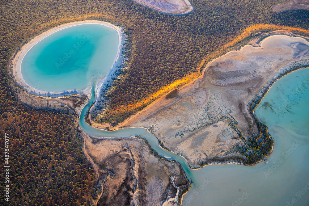 Aerial view of tidal lake with turquoise water at sunrise in remote Francois Peron National Park in Western Australia