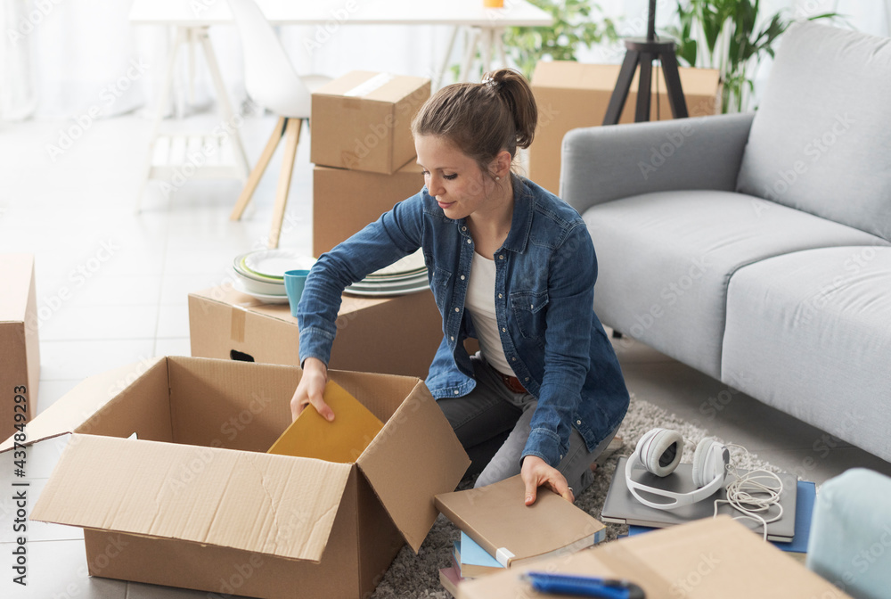 © StockPhotoPro - Young woman moving in her new apartment