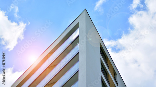 Modern apartment buildings on a sunny day with a blue sky. Facade of a modern apartment building. Glass surface with sunlight.