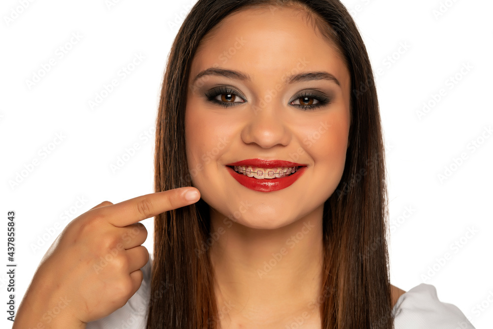woman pointing on her dentures woman pointing on her dentures