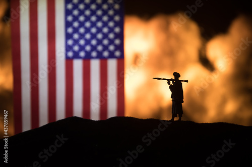 Flag on burning dark background. Concept of crisis of war and political conflicts between nations. Selective focus photo