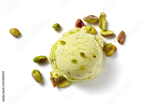 Scoop of pistachio ice cream with pistachio nuts on white background. Top view of ice cream isolated for package design of pistachio ice cream. photo