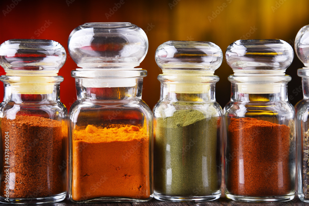 Glass storage jars with spices and herbs Glass storage jars with spices and herbs