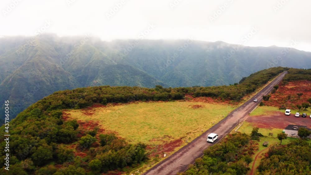 Aerial view of a van driving high in the Mountains of Madeira - tracking, drone shot Aerial view of a van driving high in the Mountains of Madeira - tracking, drone shot