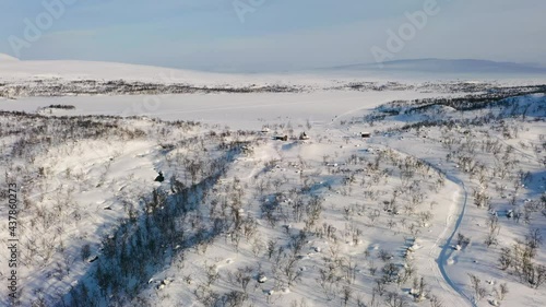 Aerial view of lake Tshahkajarvi, sunny day, in Lapland - rising, drone shot photo