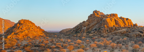Erongo mountains in central Namibia: panorama landscape with eroded granite rocks and hills at sunrise photo