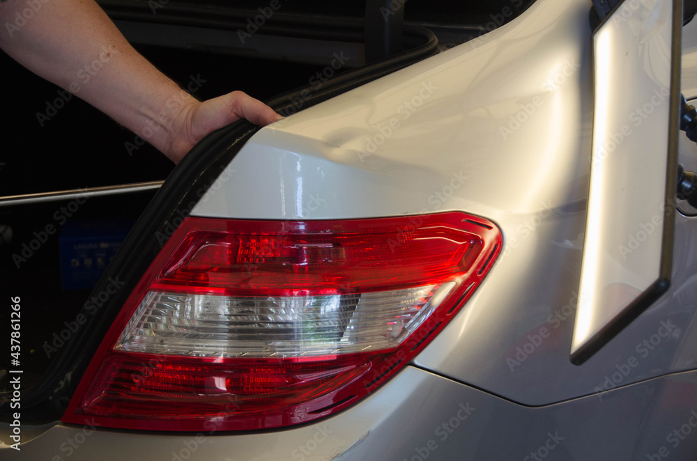 Professional Paintless Dent Repair Technician Is Repairing Dents On Car Body. Hands Of Car Mechanic. Process Of Removing Dent On Car Fender After Accident. PDR Removal Course Training
