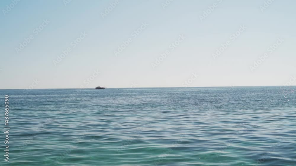 A beautiful cinematic view of an expensive luxury yacht on the horizon A beautiful cinematic view of an expensive luxury yacht on the horizon