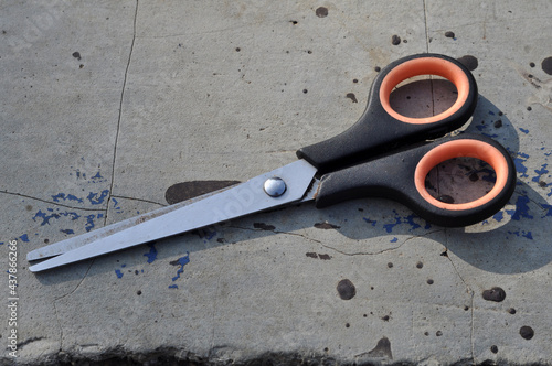 Used modern scissors are placed outdoors