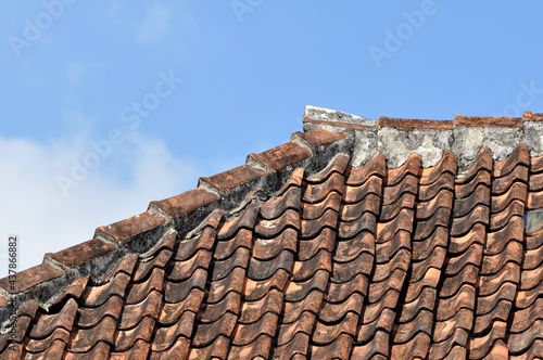 Traditional tile roof in a village in Indonesia with blue sky