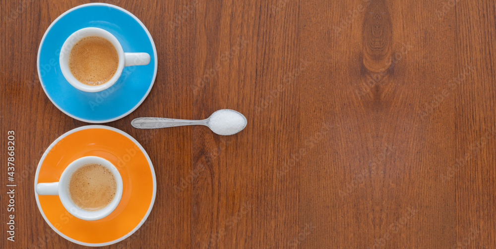 Cups of coffee with spoon on wooden background from top Cups of coffee with spoon on wooden background from top