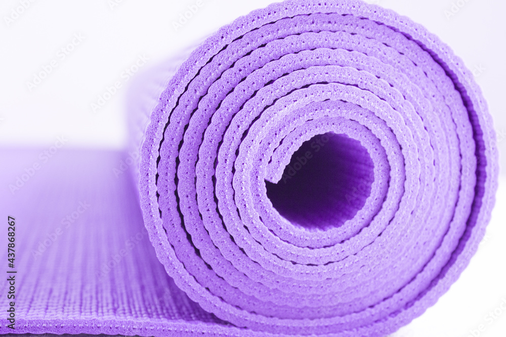 Naklejka premium Rolled up yoga or pilates mat