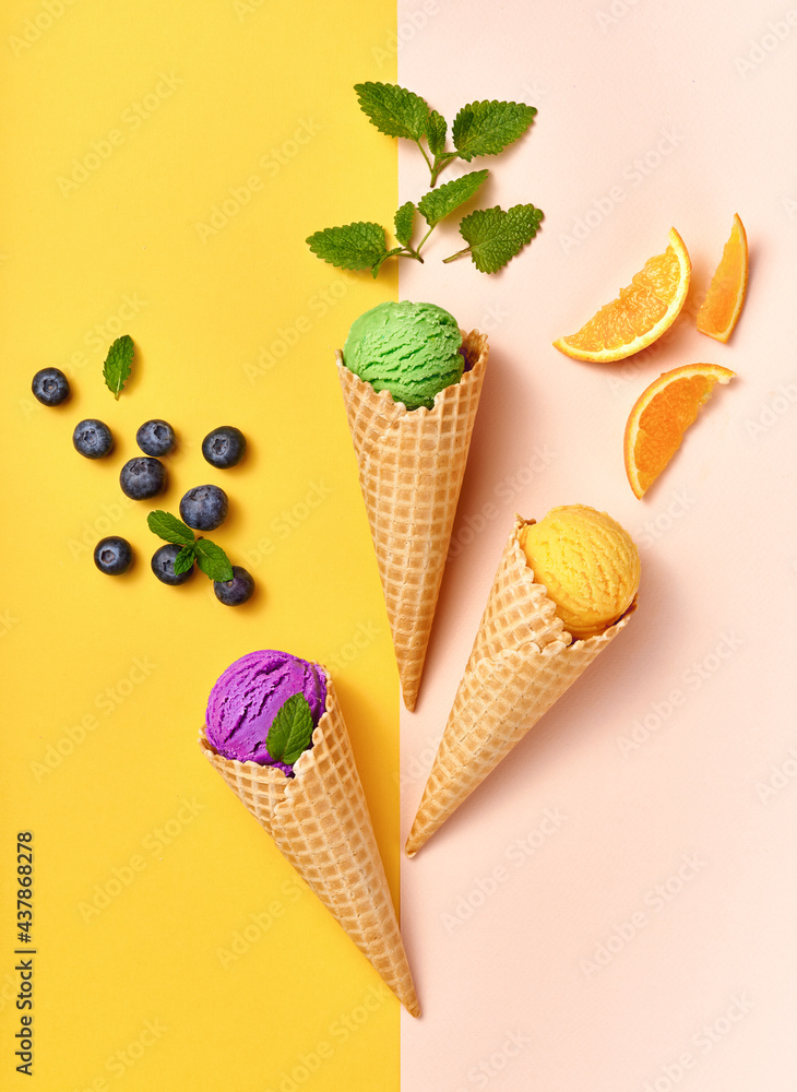 Assorted of ice cream in cones on white background. Colorful set of ice cream of different flavours. Ice cream isolated with nuts, fruits and berries. Poster for interior. Assorted of ice cream in cones on white background. Colorful set of ice cream of different flavours. Ice cream isolated with nuts, fruits and berries. Poster for interior.