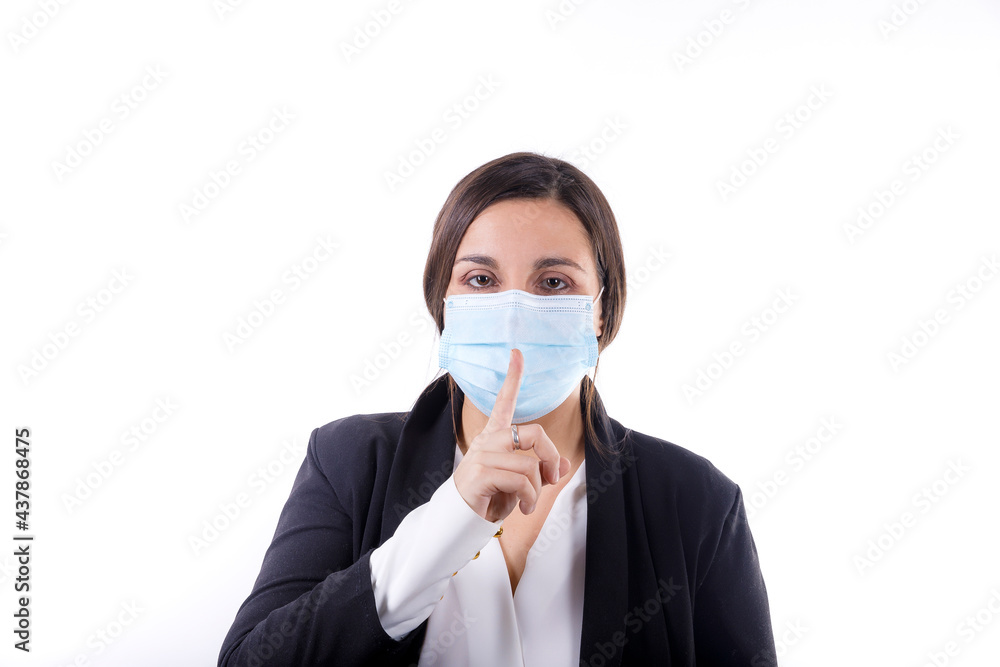 Young office worker girl dressed in a suit isolated over white background making the gesture of silence with mask isolated on white background Young office worker girl dressed in a suit isolated over white background making the gesture of silence with mask isolated on white background