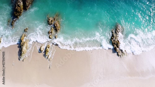 4K Aerial drone top down view bird eye view of sea blue waves break on rock and sand. Beautiful of sea water wave come to beach. Phuket Thailand tropical beach