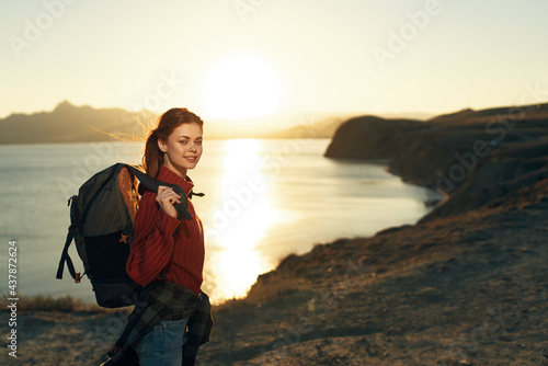 woman with backpack travel nature rocky mountains landscape sunset