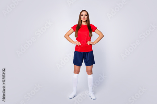 Full size photo soccer footballer world league player girl ready win match competition tournament wear red t-shirt blue shorts white sneakers socks uniform isolated gray color background